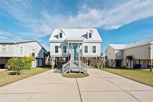 beach home featuring a front yard and a carport