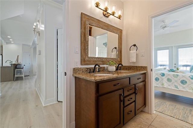 bathroom featuring wood-type flooring, vanity, and ceiling fan