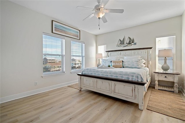 bedroom featuring multiple windows, light wood-type flooring, and ceiling fan