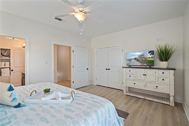 bedroom with ceiling fan, light hardwood / wood-style floors, ensuite bathroom, and a closet