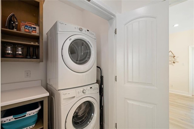 laundry area featuring stacked washing maching and dryer