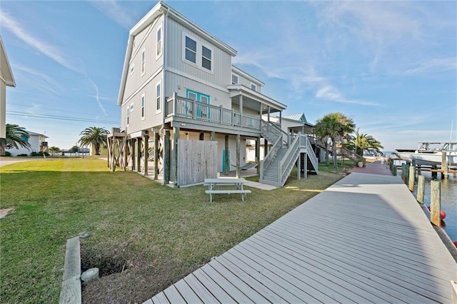 rear view of house featuring a yard and a water view