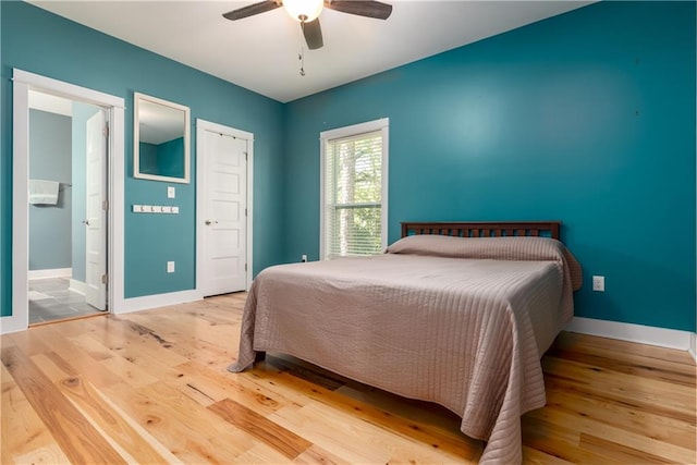 bedroom featuring ensuite bathroom, light wood-type flooring, and ceiling fan