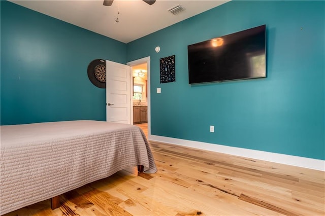 unfurnished bedroom featuring sink, light wood-type flooring, and ceiling fan