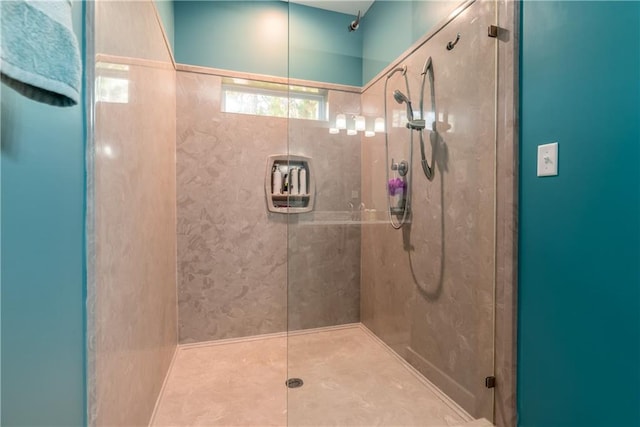 bathroom featuring a shower with shower door and tile patterned floors