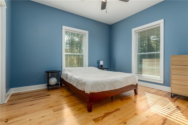 bedroom with light hardwood / wood-style floors and ceiling fan