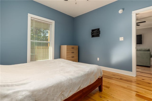 bedroom featuring wood-type flooring and ceiling fan