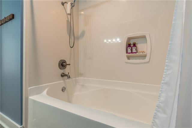 bathroom with shower / bathtub combination with curtain