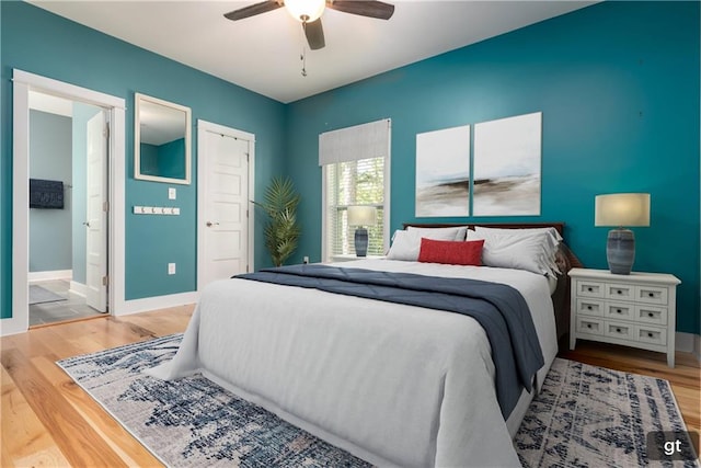 bedroom featuring ensuite bathroom, hardwood / wood-style flooring, and ceiling fan