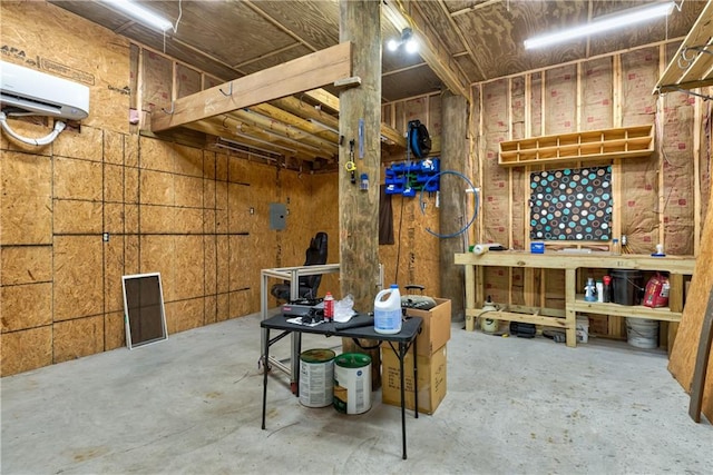 basement featuring a workshop area and a wall unit AC