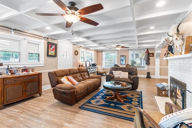 living room with baseboards, light wood-style floors, a ceiling fan, and coffered ceiling
