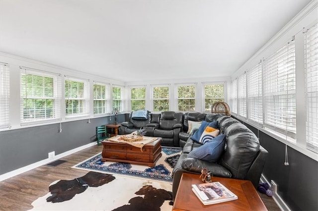 sunroom with visible vents, wood finished floors, and baseboards
