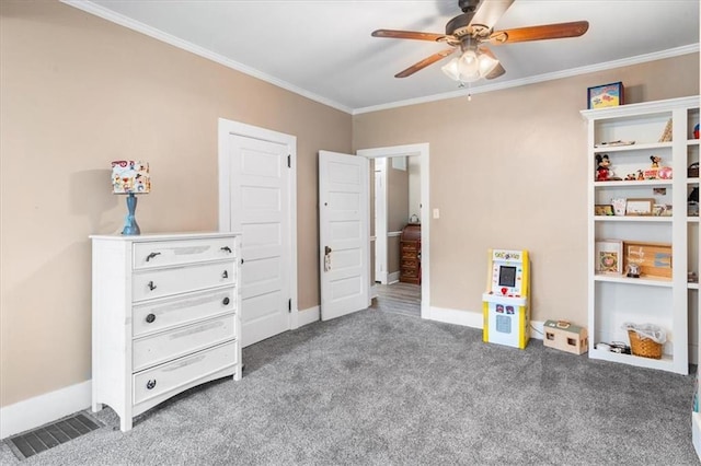 bedroom featuring visible vents, baseboards, carpet floors, ornamental molding, and a ceiling fan