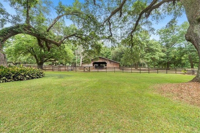 view of yard featuring an outdoor structure, an exterior structure, an outbuilding, and fence