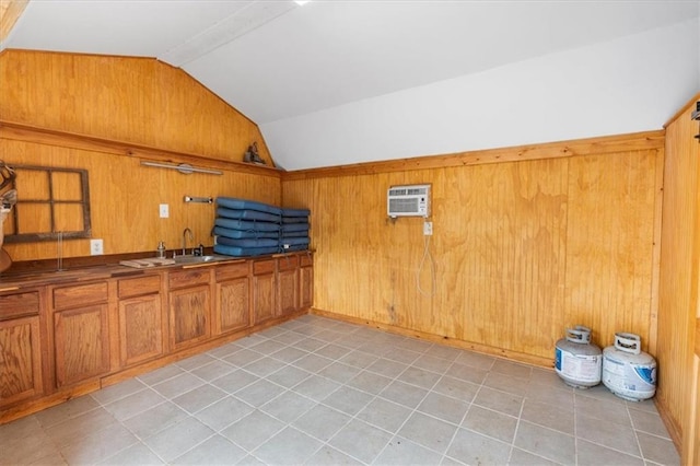 interior space featuring a wall mounted air conditioner, wooden walls, and a sink