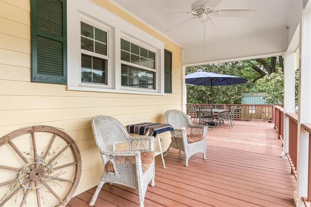 wooden deck with ceiling fan and outdoor dining area