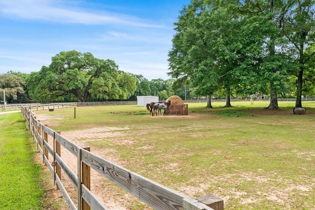 view of yard featuring fence and a rural view
