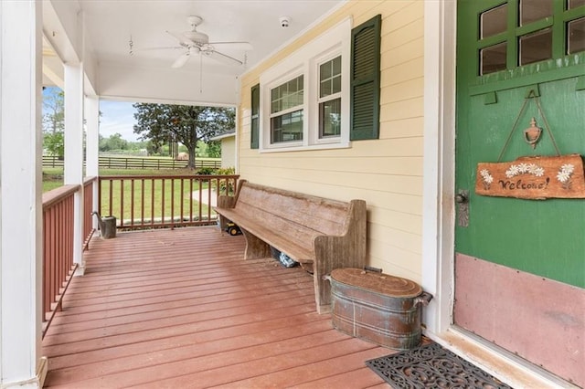 wooden deck with a porch and a ceiling fan