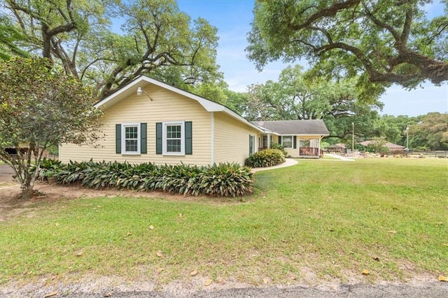 view of side of property with a yard