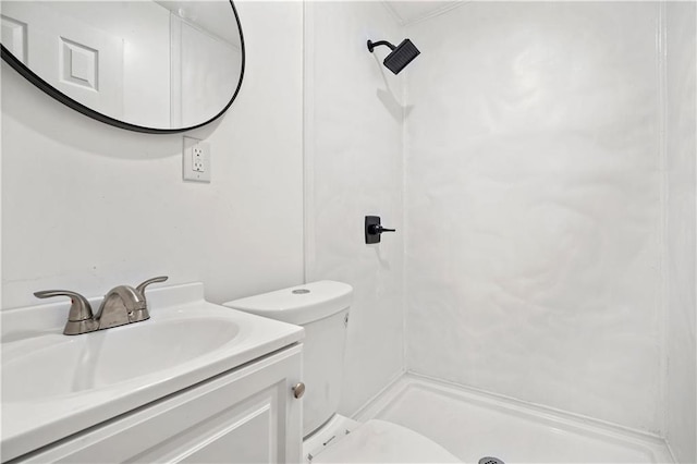 bathroom with walk in shower, vanity, and toilet