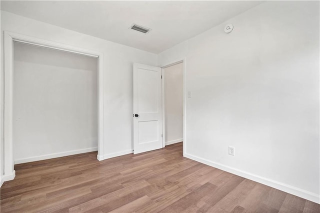 unfurnished bedroom featuring hardwood / wood-style flooring