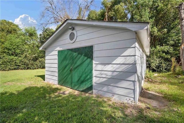 view of outbuilding with a lawn