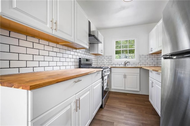 kitchen featuring wood counters, white cabinetry, decorative backsplash, stainless steel appliances, and dark hardwood / wood-style flooring