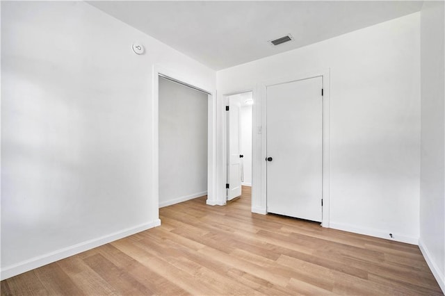 spare room with light wood-type flooring