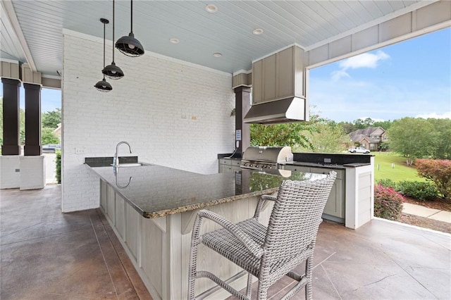 view of patio with area for grilling, sink, and an outdoor kitchen