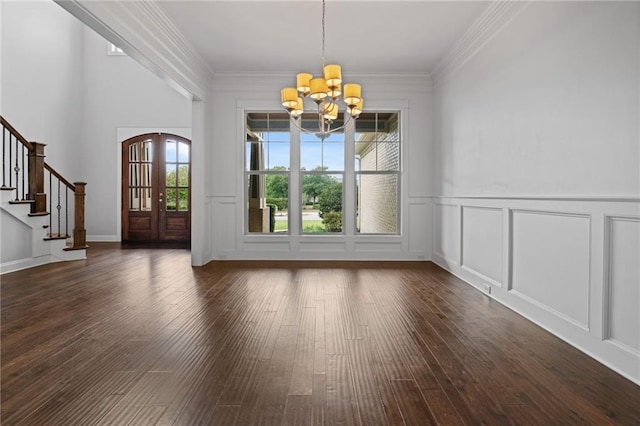 unfurnished dining area with crown molding, dark hardwood / wood-style flooring, and a notable chandelier