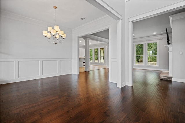 unfurnished dining area with an inviting chandelier, dark hardwood / wood-style floors, crown molding, and a healthy amount of sunlight