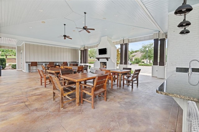 dining space featuring wood ceiling, ceiling fan, brick wall, and high vaulted ceiling