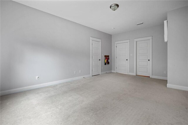 unfurnished bedroom with light colored carpet