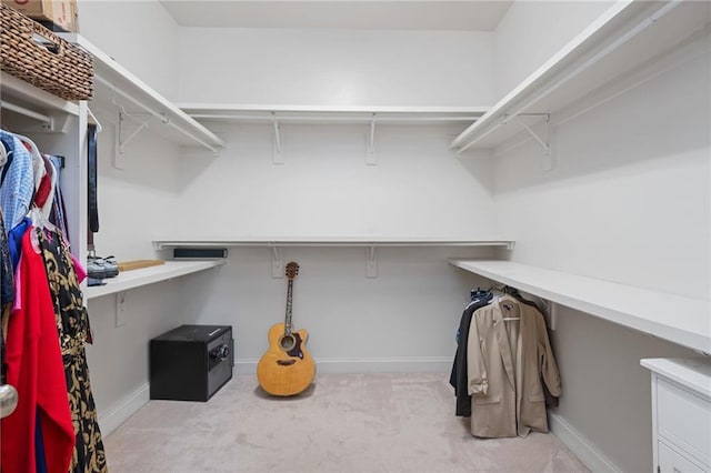 spacious closet featuring light carpet