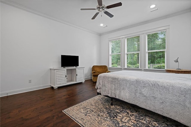 bedroom with crown molding, dark hardwood / wood-style floors, and ceiling fan