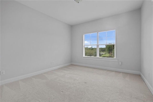 unfurnished room featuring light colored carpet