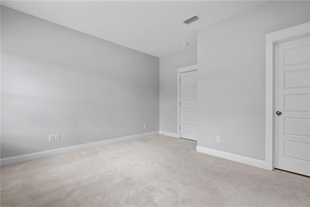 spare room with light colored carpet