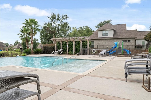 view of pool with a pergola, a water slide, and a patio area