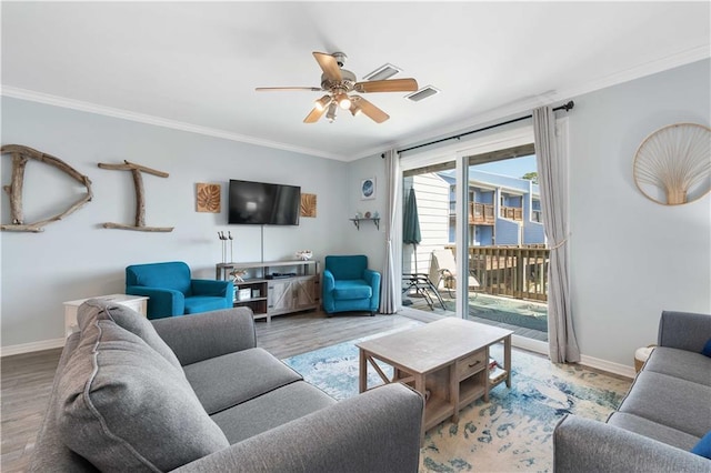 living room featuring hardwood / wood-style floors, ceiling fan, and crown molding