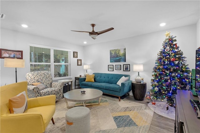 living room with hardwood / wood-style flooring and ceiling fan