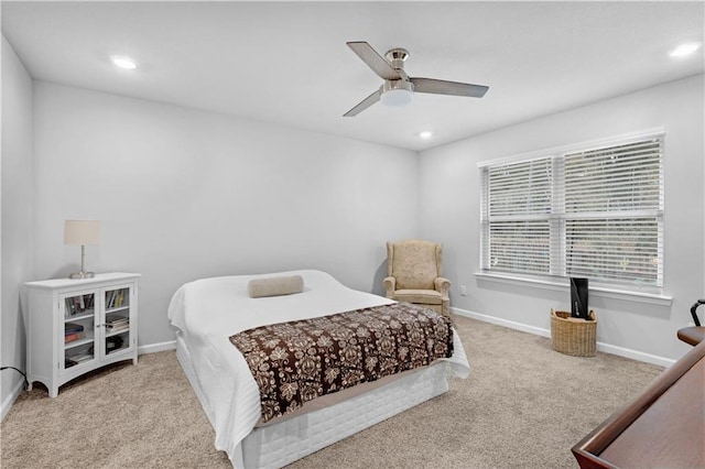 bedroom featuring light colored carpet and ceiling fan