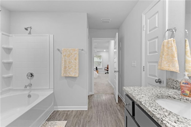 bathroom with vanity, wood-type flooring, and bathtub / shower combination