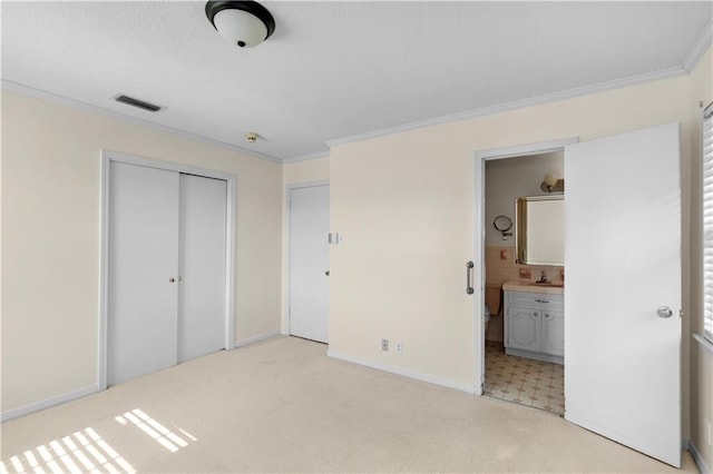 720 Grand Bay-Wilmer Rd N, Mobile, AL 36608 - unfurnished bedroom featuring ornamental molding, a closet, baseboards, light colored carpet, and connected bathroom