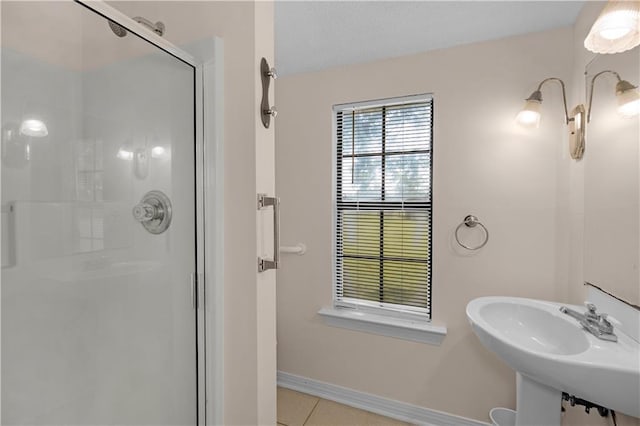 720 Grand Bay-Wilmer Rd N, Mobile, AL 36608 - bathroom featuring a shower stall, tile patterned flooring, baseboards, and a sink