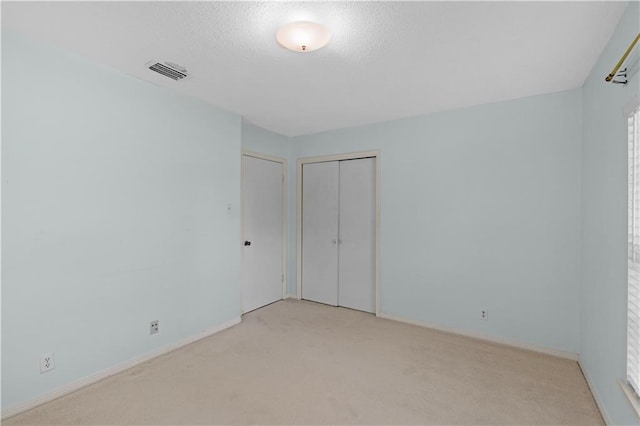 720 Grand Bay-Wilmer Rd N, Mobile, AL 36608 - unfurnished bedroom with carpet floors, a closet, baseboards, and a textured ceiling