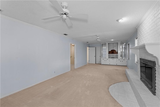 720 Grand Bay-Wilmer Rd N, Mobile, AL 36608 - unfurnished living room with ceiling fan, a fireplace, light carpet, ornamental molding, and a textured ceiling