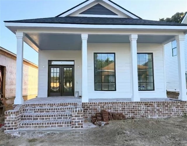253 N Dearborn St, Mobile, AL 36603 - property entrance featuring a porch, roof with shingles, and french doors