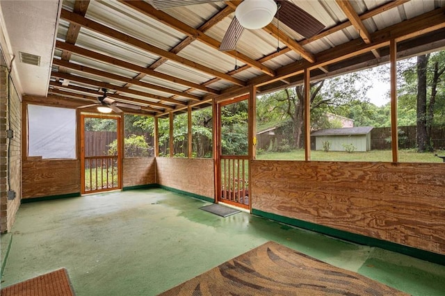 unfurnished sunroom featuring visible vents and ceiling fan