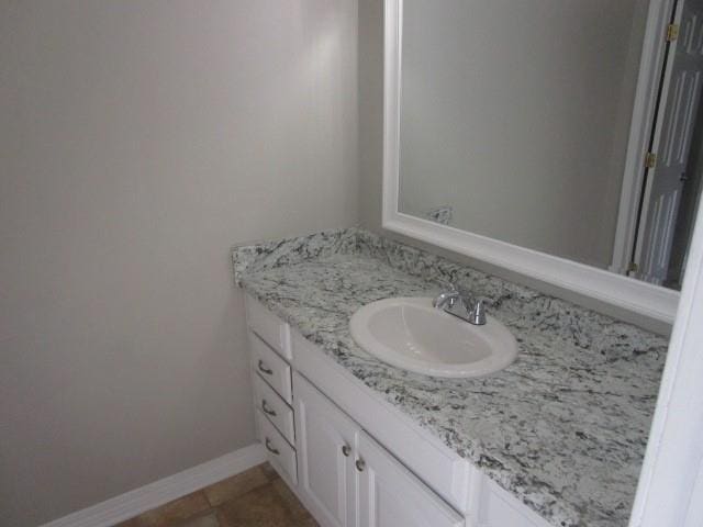 bathroom with tile patterned flooring and vanity