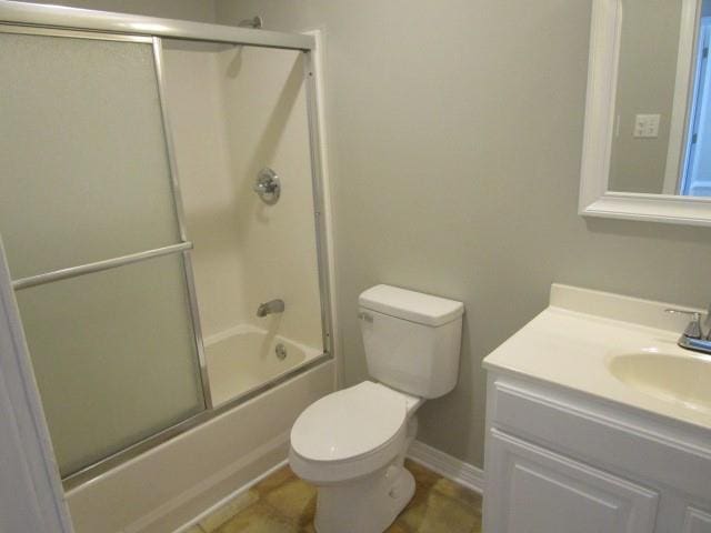 full bathroom featuring vanity, toilet, and enclosed tub / shower combo